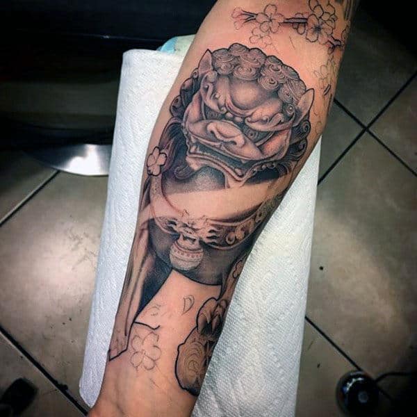 Gentleman With Cool Foo Dog Forearm Tattoo Design