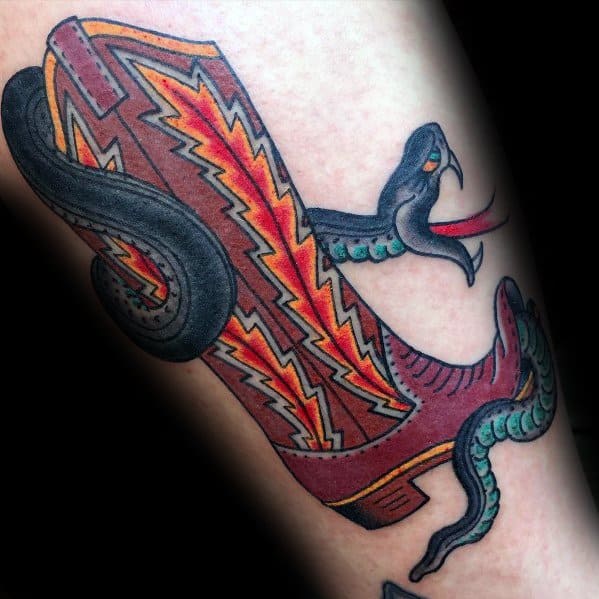 Tattoo of a bold, lightning-patterned cowboy boot with a striking snake, symbolizing power, danger, and the untamed spirit of the Wild West.