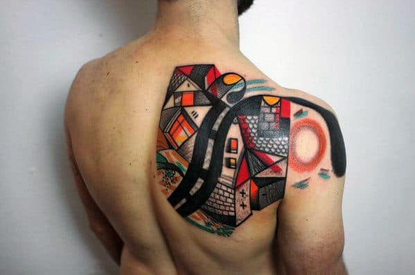 Cubist tattoo on upper back featuring an abstract village with winding roads, houses, and a sun in bold red, black, and orange tones.