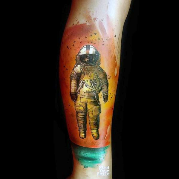 Watercolor-style Deja Entendu astronaut tattoo with orange sky, birds, and green ocean, blending surrealism with soft color tones.