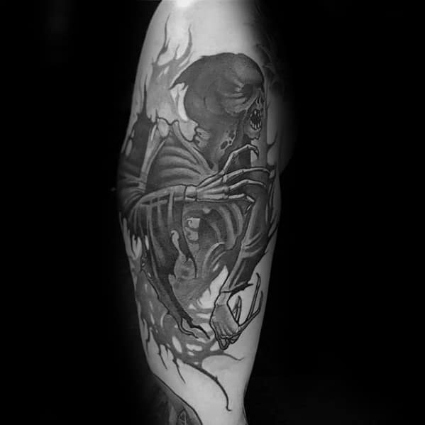 Terrifying Dementor tattoo showing skeletal details, gaping mouth, and clawed hands in dark black and grey realism.