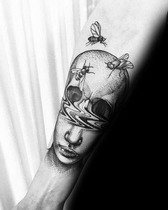 Surreal tattoo of a woman's face merging with a skull, featuring flies on the head and intricate dotwork for a dreamlike, haunting effect.