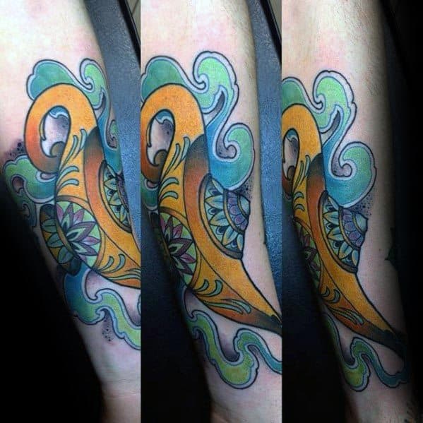 A colorful abstract tattoo with a swirling genie lamp in orange, blue, and green