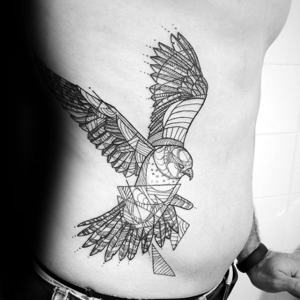 Large geometric falcon tattoo on the ribcage, featuring intricate linework, dot shading, and abstract patterns for a bold, dynamic look.