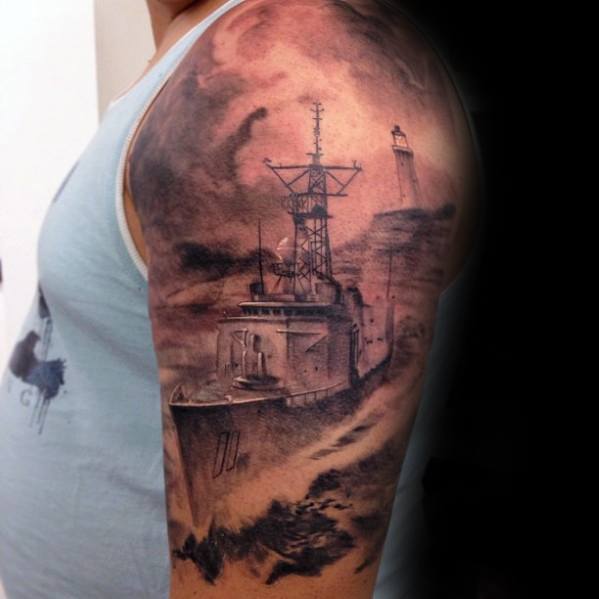 A battleship and lighthouse tattoo on a person's arm