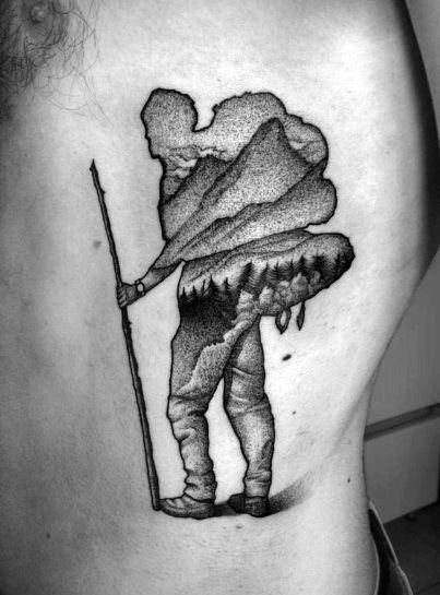 A black and gray tattoo of a hiker with a mountain landscape integrated into their silhouette, symbolizing adventure, exploration, and nature.