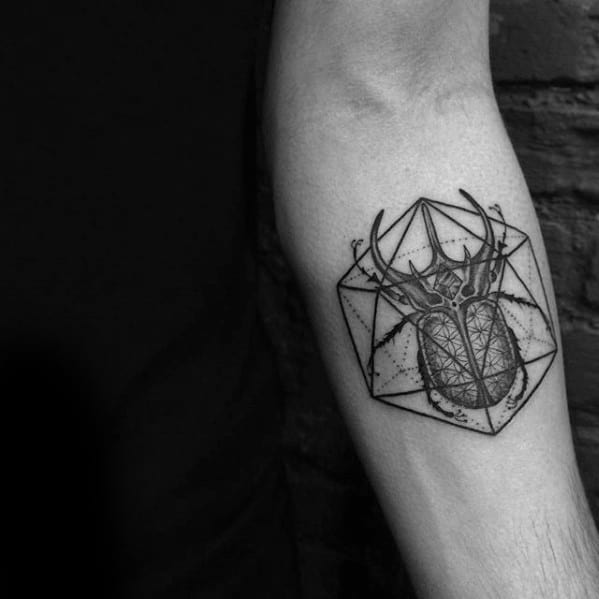 Stag and icosahedron tattoo on forearm blending nature with geometry, featuring fine lines and a cosmic-style background.