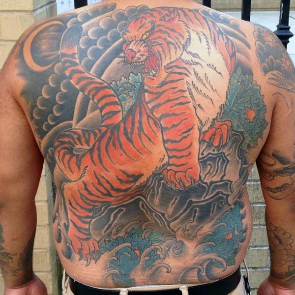 Gentleman With Japanese Tiger Standing On Rock Back Tattoo