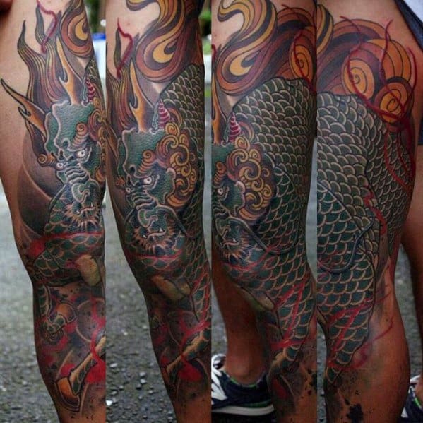 Full-leg Kirin tattoo with green scales, golden mane, red flames, and swirling patterns wrapping around the calf in a dynamic design.