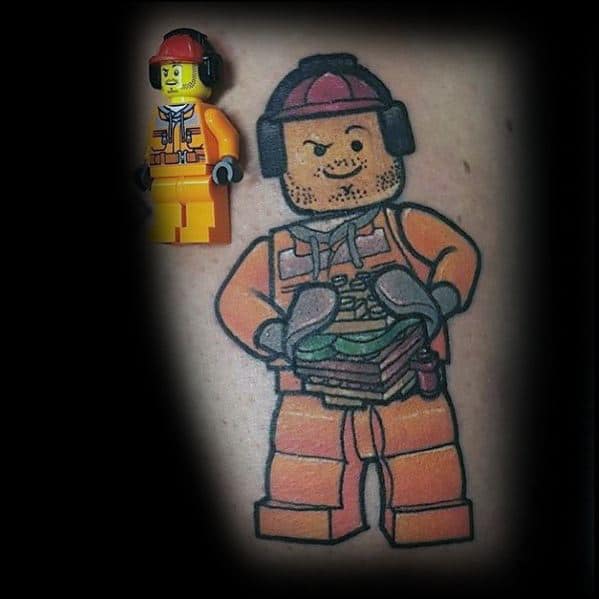 Tattoo of a Lego construction worker in orange gear holding sandwiches, with stubble, red cap, and earmuffs, next to the original minifig.
