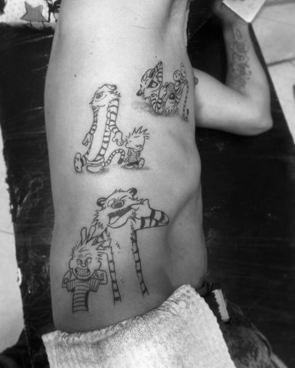 Gentleman With Multiple Calvin And Hobbes Tattoos On Ribs