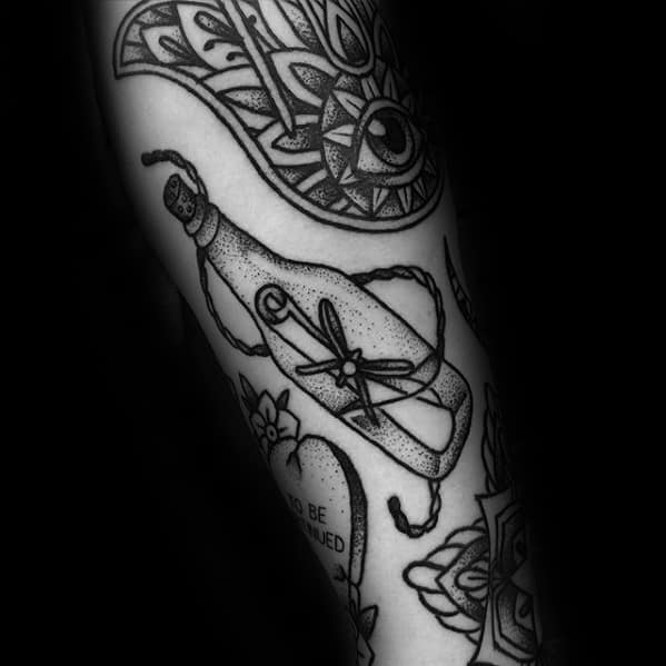 Black and white tattoos: eye, heart, abstract designs, message in a bottle