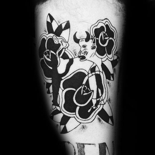 Tattoo of Picasso’s bull surrounded by bold black roses and geometric shapes, blending cubist and traditional styles for a striking design.