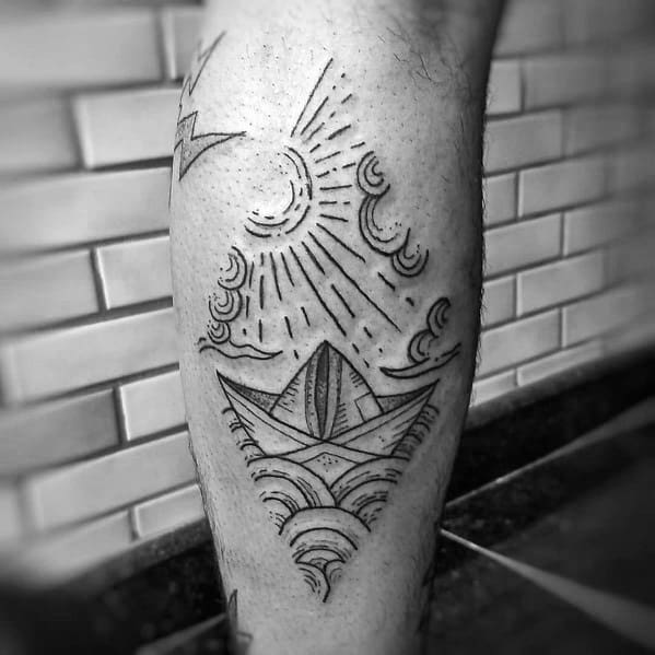 Paper boat tattoo with waves, sun, and clouds, symbolizing hope, resilience, and the journey through life’s challenges.