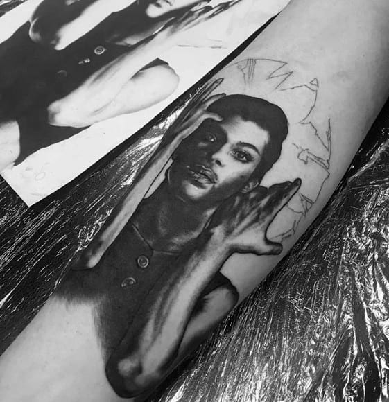 A stunning tattoo, showcasing Prince's iconic pose with meticulous attention to detail