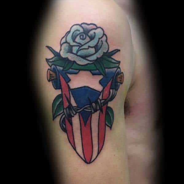 Puerto Rican flag tattoo with a white rose and barbed wire design, symbolizing resilience, pride, and heritage in a bold, artistic style.