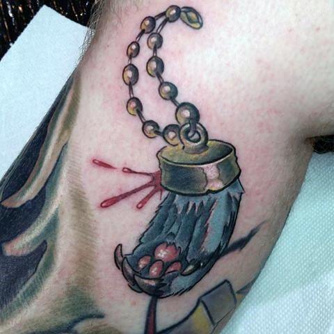 Gentleman With Rabbit Foot Tattoo On Leg