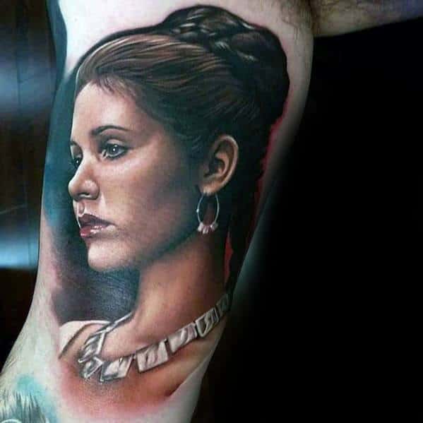 Tattoo of a woman with braided hair, wearing earrings and a necklace, on someone's arm