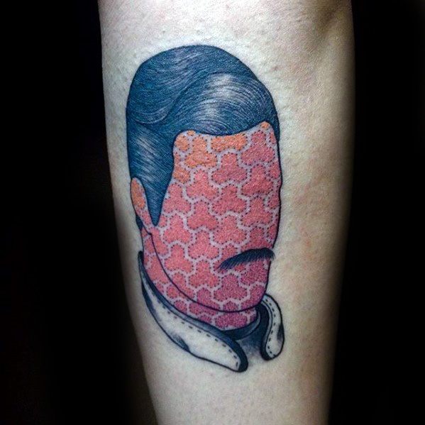 Abstract Freddie Mercury tattoo with patterned face and slicked hair, blending minimalist portrait style with creative geometric texture.