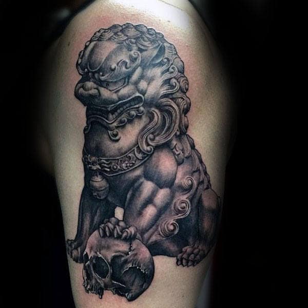 Gentleman With Shaded Foo Dog Statue And Skull Tattoo On Arm