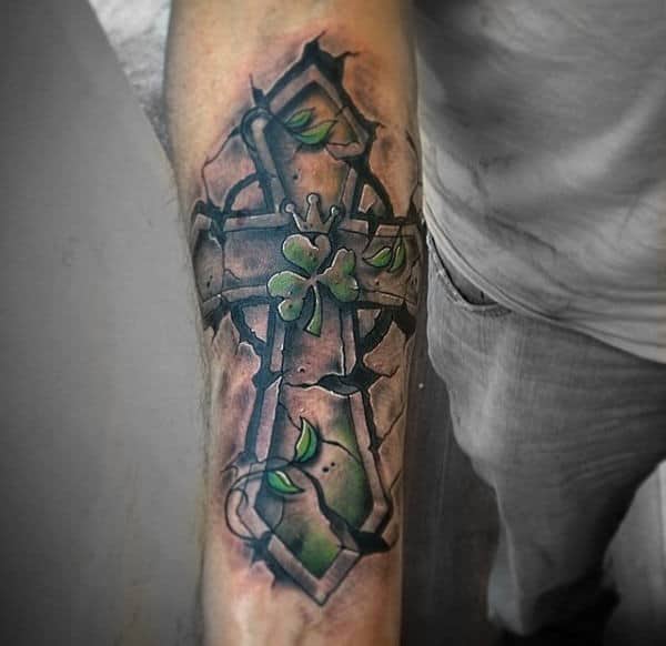 Gentleman With Shamrock Cross Tattoos On Forearm