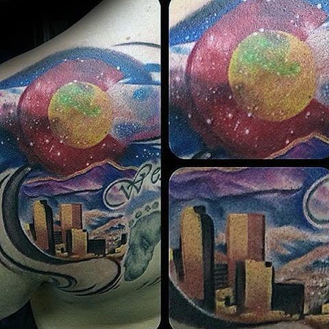 Vibrant Denver skyline chest tattoo with the Colorado flag, snowy mountains, and a cosmic night sky with stars and swirling clouds.