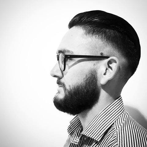 Gentleman With Slicked Back Hair And Skin Fade Sides