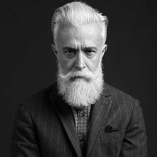 Gentleman With Slicked Back Old School Hair And Beard