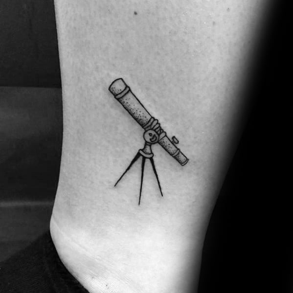 Telescope tattoo beautifully etched on someone's skin
