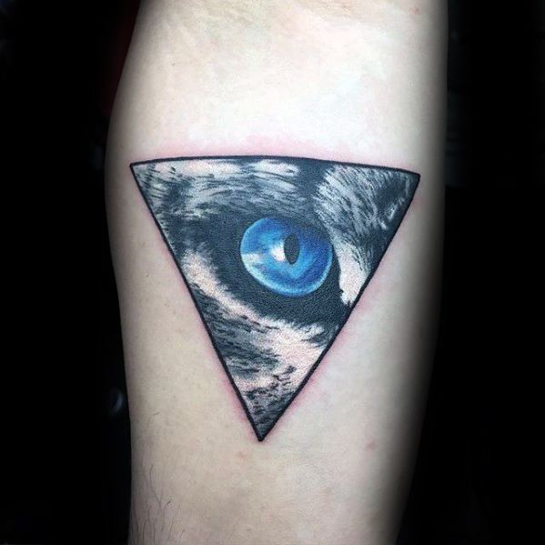 Geometric snow leopard tattoo featuring a vivid blue eye inside a black triangle, blending realism with minimalist design.