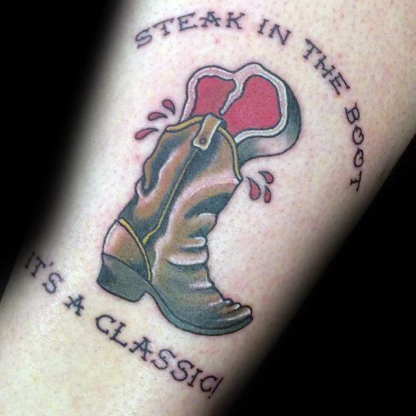 Tattoo of a cowboy boot with a steak inside, featuring the phrase steak in the boot it's a classic, blending humor with Western style