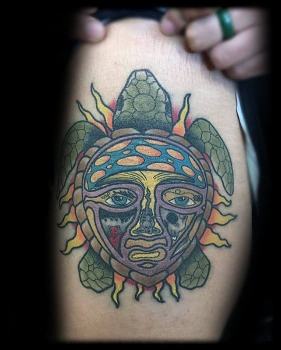 Tattoo of a turtle with a Sublime sun face shell, blending ocean symbolism with the band’s iconic fiery sun design.
