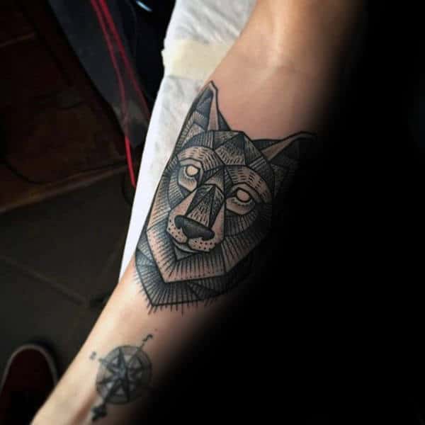 Gentleman With Tattoo Of Geometric Wolf On Forearm