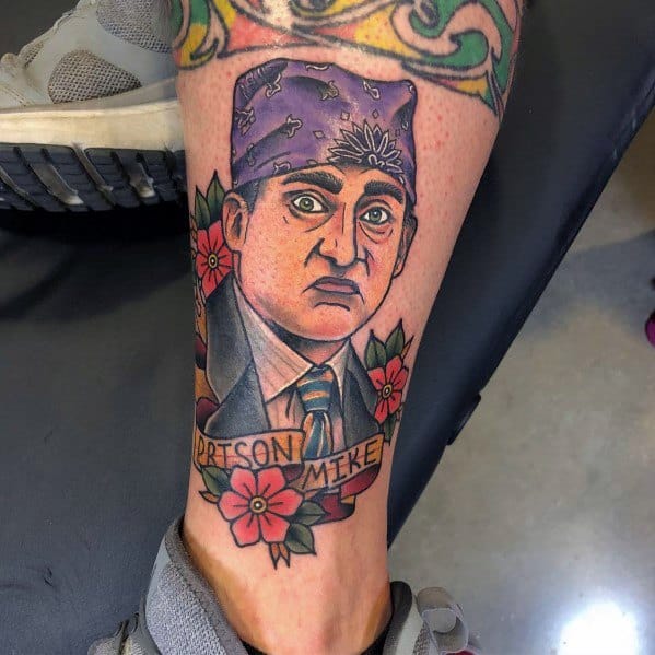 Color tattoo of Michael Scott as "Prison Mike" from The Office, featuring his signature purple bandana and surrounded by flowers.