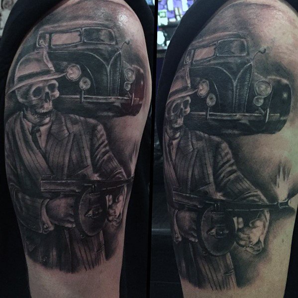Black and grey gangster-themed tattoo featuring a skeleton in a pinstripe suit holding a Tommy gun, with a vintage car in the background.