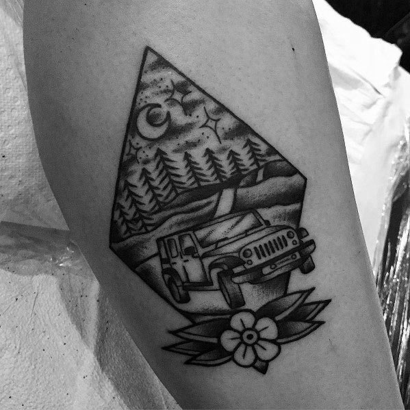 Black and grey Jeep tattoo in a geometric frame, featuring an off-road Jeep on a winding forest road under a starry night sky with a moon.