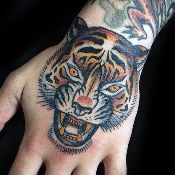 Tattoo of a roaring tiger's face on the back of a hand