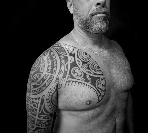 Gentleman With Tribal Shoulder And Half Sleeve Tattoo On Body