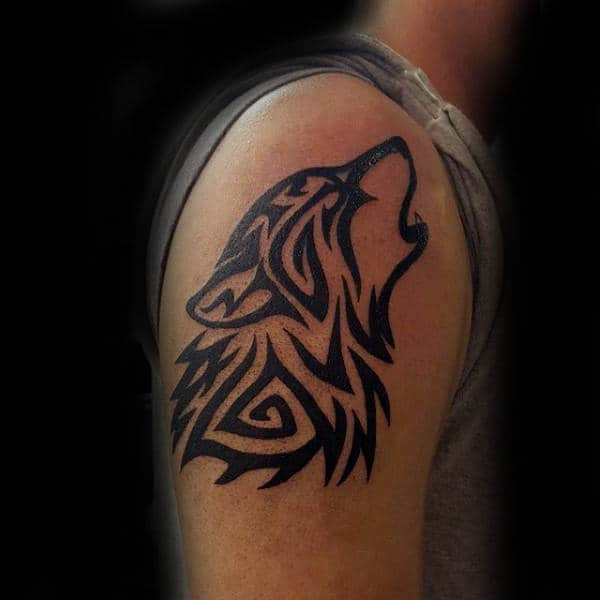 Gentleman With Tribal Wolf Upper Arm Howling Tattoo