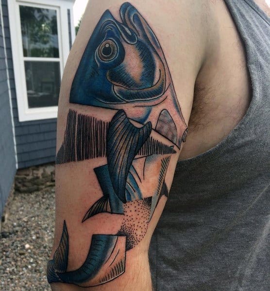 Abstract blue tuna fish tattoo on a man's upper arm, featuring geometric shapes, bold shading, and a modern artistic design.