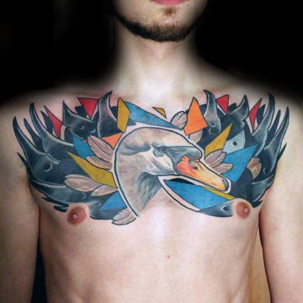 Colorful chest tattoo of a swan with geometric feathers in bold red, blue, yellow, and black, blending nature with abstract art.