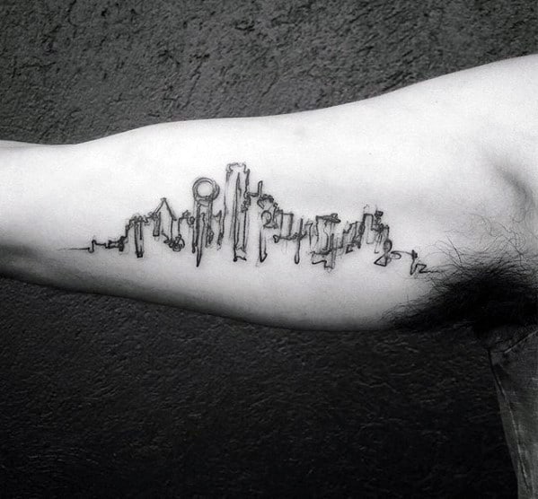 Minimalist Dallas skyline tattoo on the inner bicep, featuring thin black lines with a dripping ink effect for a modern, abstract style.