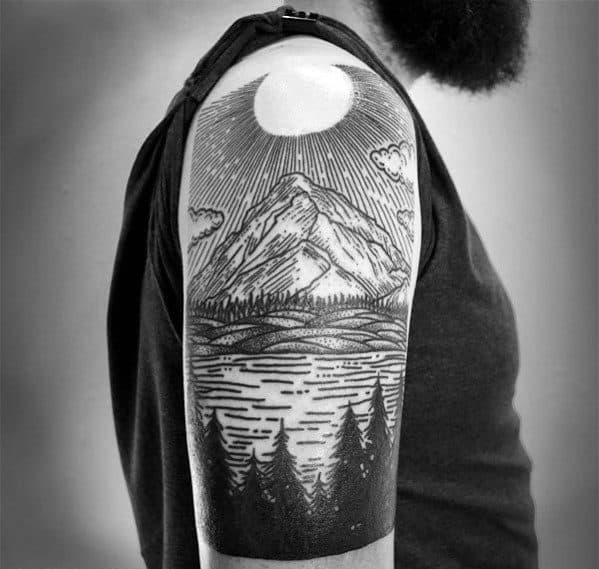 Bold blackwork lake tattoo with mountain peak, radiant sun, calm water, and a dark forest silhouette wrapping the upper arm.