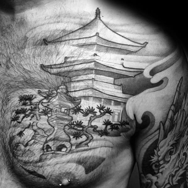Black and grey chest tattoo of a Japanese pagoda with bonsai trees and clouds, blending traditional architecture with nature elements.