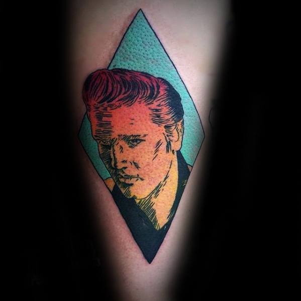 Stylized Elvis Presley tattoo in a diamond frame with bold outlines and retro color palette of teal, orange, and red.