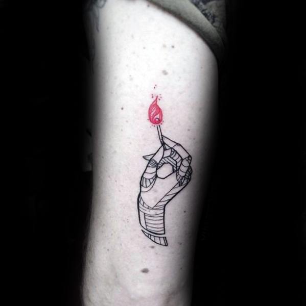 Minimalist tattoo of a bandaged hand holding a red flame matchstick, symbolizing resilience, inner strength, and the power to reignite.