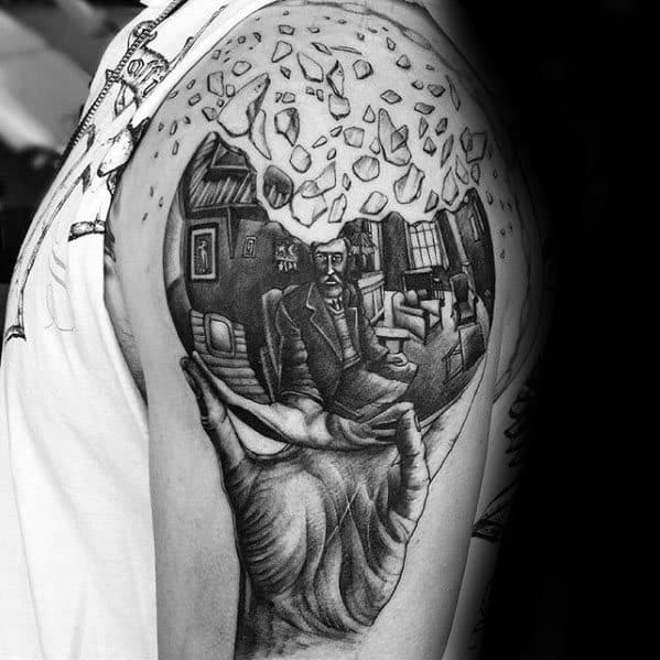 Tattoo of Escher’s “Hand with Reflecting Sphere,” with shattered glass above, adding a surreal twist to the iconic self-portrait.