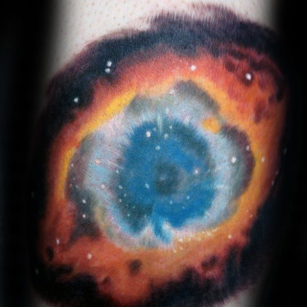 Nebula tattoo of an eye with vibrant orange, blue, and white hues resembling a colorful cosmic scene