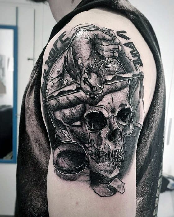 Dark upper arm tattoo of a skull with a hammer, blood splatter, and text Kill Hope Kill Love, inspired by Metallica’s brutal themes.