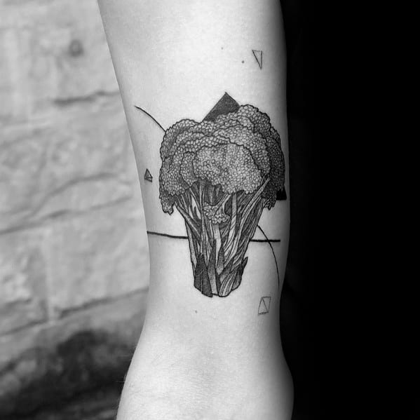 Geometric broccoli tattoo on the forearm, featuring fine linework, shading, and abstract elements for a modern and artistic design.